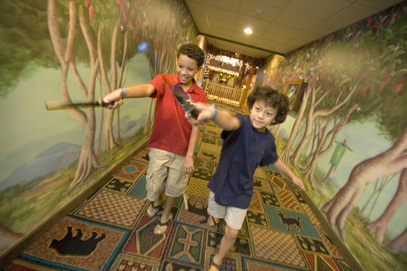 Two young boys pointing their magic wands